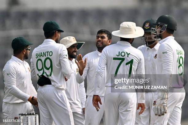 Bangladesh's Mehidy Hasan Miraz celebrates with teammates after taking the wicket of New Zealand's Henry Nicholls during the fourth day of the second...