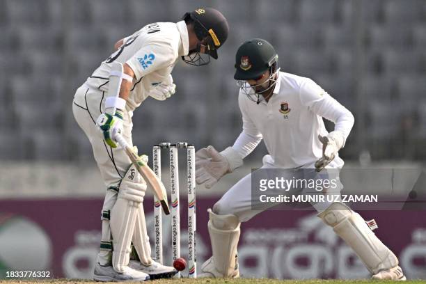 New Zealand's Tom Latham gestures after playing a shot as Bangladesh's Nurul Hasan watches during the fourth day of the second Test cricket match...