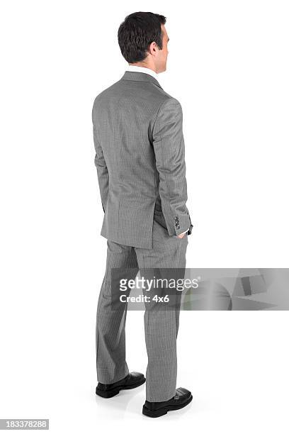 uomo d'affari con le mani nelle tasche - grey suit foto e immagini stock