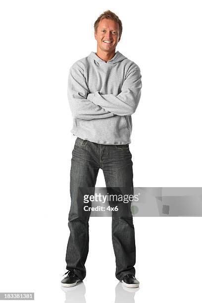 casual male smiling arms folded - gray jeans stockfoto's en -beelden