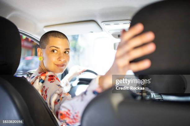 woman is driving a car on her way to work - reversing stock pictures, royalty-free photos & images