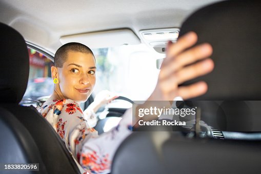 Woman is driving a car on her way to work Woman is driving a car on her way to work