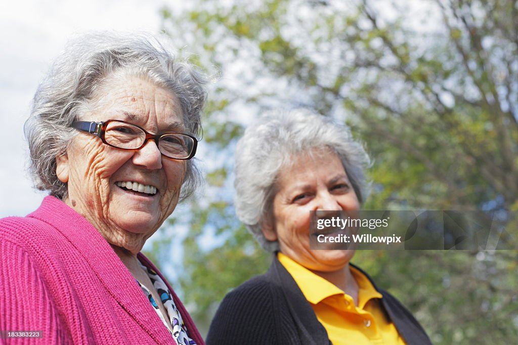 Senior Woman Mother and Mature Daughter Grinning at Camera