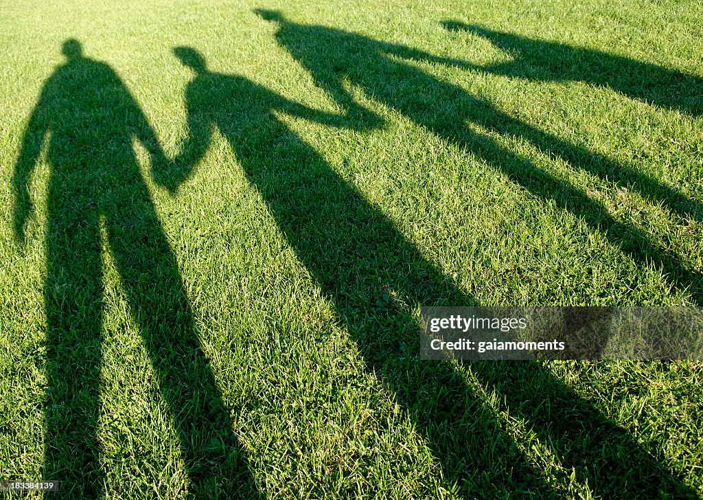Family of four shadows in the park