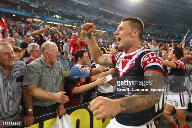 Shaun Kenny-Dowall of the Roosters celebrates with fans after winning the 2013 NRL Grand Final match between the Sydney Roosters and the Manly...