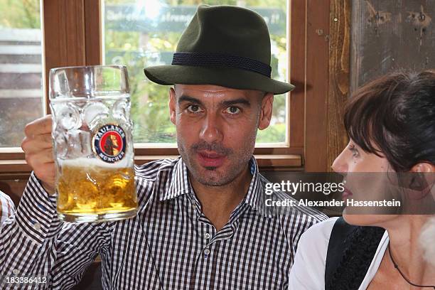 Pep Guardiola, head coach of Bayern Muenchen attends with his wife Cristina Serra the Oktoberfest 2013 beer festival at Kaefers Wiesenschaenke on...