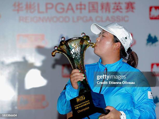 Shanshan Feng kisses her trophy during the closing ceremony of the Reignwood LPGA Classic at Pine Valley Golf Club on October 6, 2013 in Beijing,...