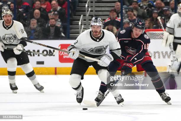 Matt Roy of the Los Angeles Kings skates with the puck against Dmitri Voronkov of the Columbus Blue Jackets during the first period at Nationwide...