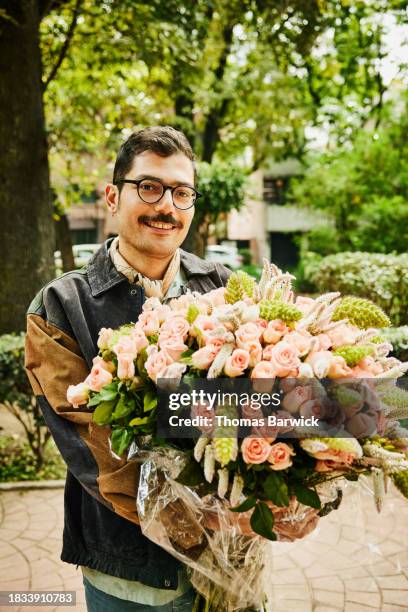 Man Carrying Roses 127 Carrying Large Bunch Of Flowers Stock Photos, High-Res Pictures ...
