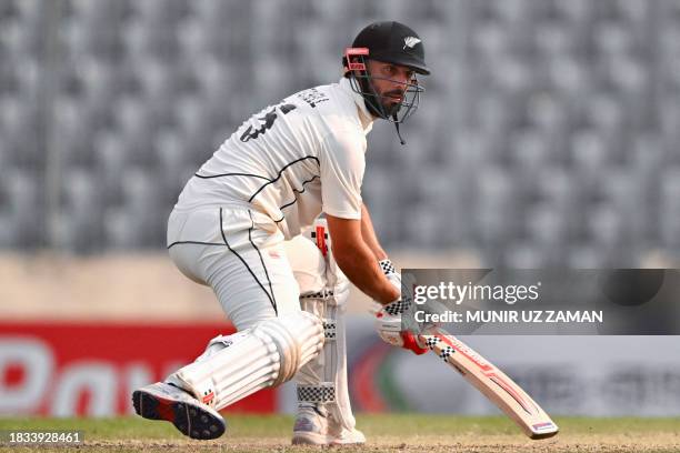 New Zealand's Daryl Mitchell watches the ball after playing a shot during the fourth day of the second Test cricket match between Bangladesh and New...