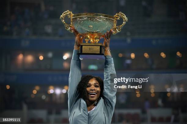 Serena Williams of the United States poses with her trophy during the medal ceremony after winning against Jelena Jankovic of Serbia on day night of...