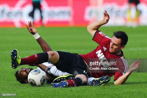 Josip Drmic of Nuernberg is challenged by Johan Djourou of Hamburg during the Bundesliga match between 1. FC Nuernberg and Hamburger SV at Grundig...