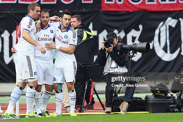 Rafael van der Vaart of Hamburg celebrates his team's first goal with team mates Pierre-Michel Lasogga and Hakan Calhanoglu during the Bundesliga...