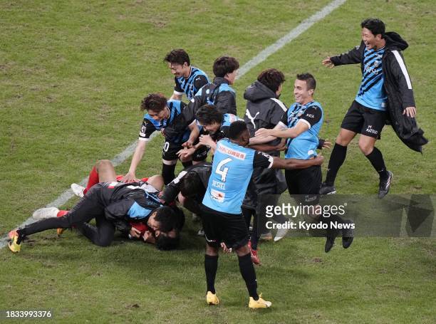 Kawasaki Frontale players celebrate after a penalty shootout win over Kashiwa Reysol in the Emperor's Cup football final on Dec. 9 at Tokyo's...