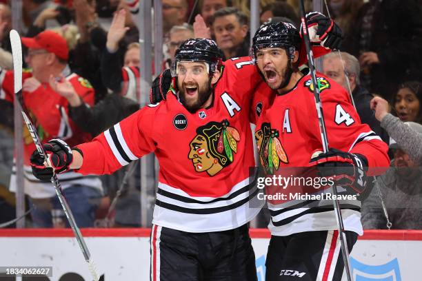 Nick Foligno of the Chicago Blackhawks celebrates with Seth Jones after scoring a goal against the Nashville Predators during the second period at...