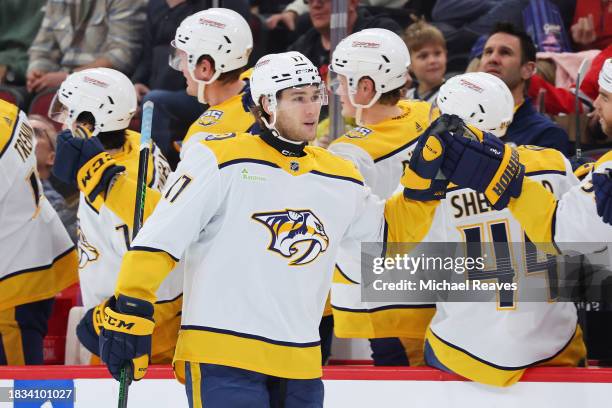 Mark Jankowski of the Nashville Predators high fives teammates after scoring a goal against the Chicago Blackhawks during the second period at the...