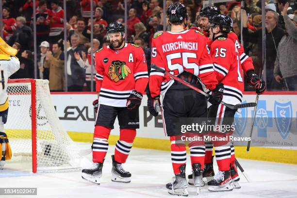 Nick Foligno of the Chicago Blackhawks celebrates with teammates after scoring a goal against the Nashville Predators during the second period at the...