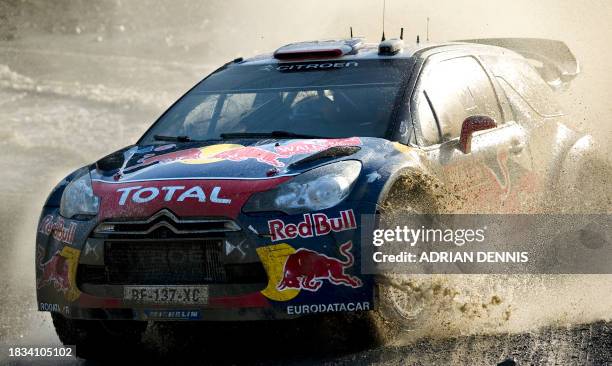 Sebastien Loeb of France and co-driver Daniel Elena drives his Citroen DS3 through a water splash at the Sweet Lamb stage during the third day of the...