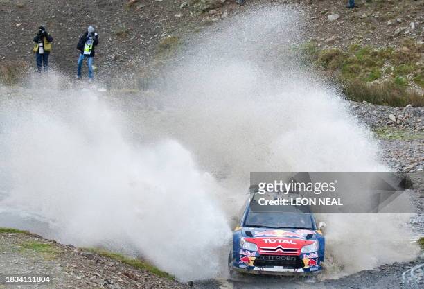 France's Sebastien Ogier drives his Citroen C4 WRC through the 'Sweet Lamb' stage on the second day of the Wales Rally GB in central Wales on...