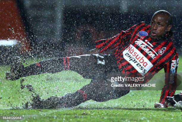 Nice's forward Habid Nomwaya Bamogo is tackled during the French L1 football match Nice vs Grenoble, on December 10, 2008 at the "Ray Stadium" in...