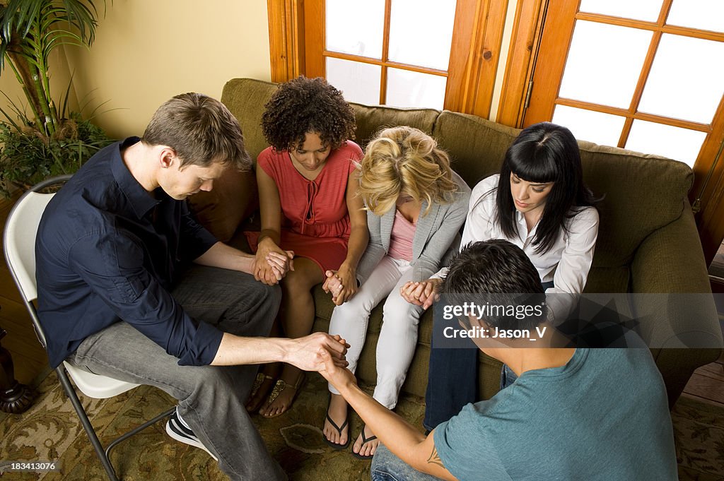 Diverse group of people praying