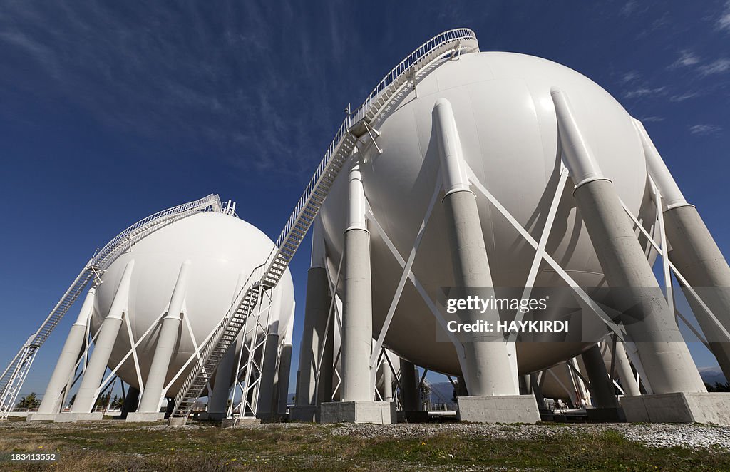 White petroleum storage tanks outside a petrochemical plant