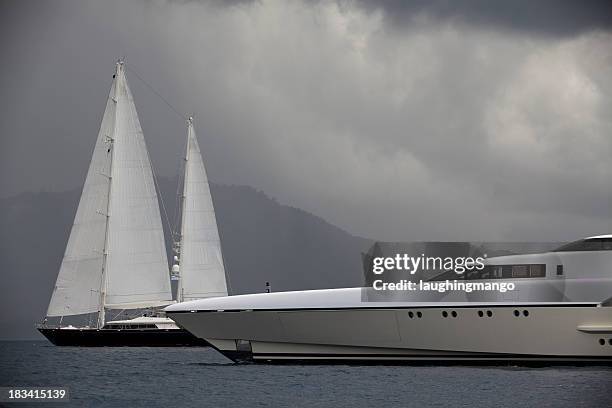 luxury yacht and sailboats before a cloudy sky - super yacht stock pictures, royalty-free photos & images