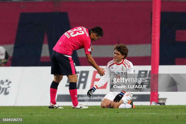 Makoto Rindo of Ehime FC is consoled by Teruyuki Moniwa of Cerezo Osaka after the J.League J1 Promotion Play-Off semi-final between Cerezo Osaka and...