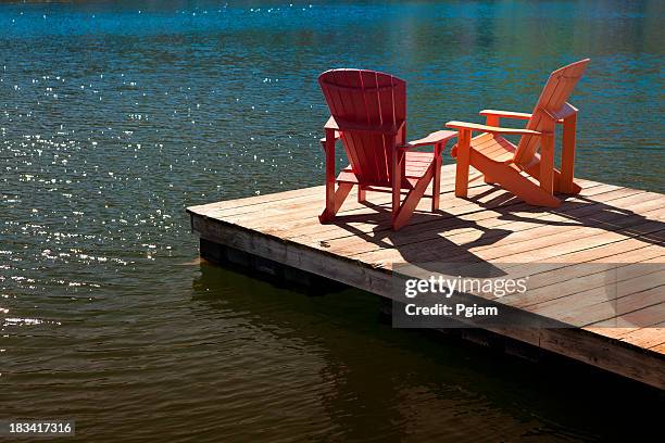 adirondack chairs on a dock - cottage dock stock pictures, royalty-free photos & images