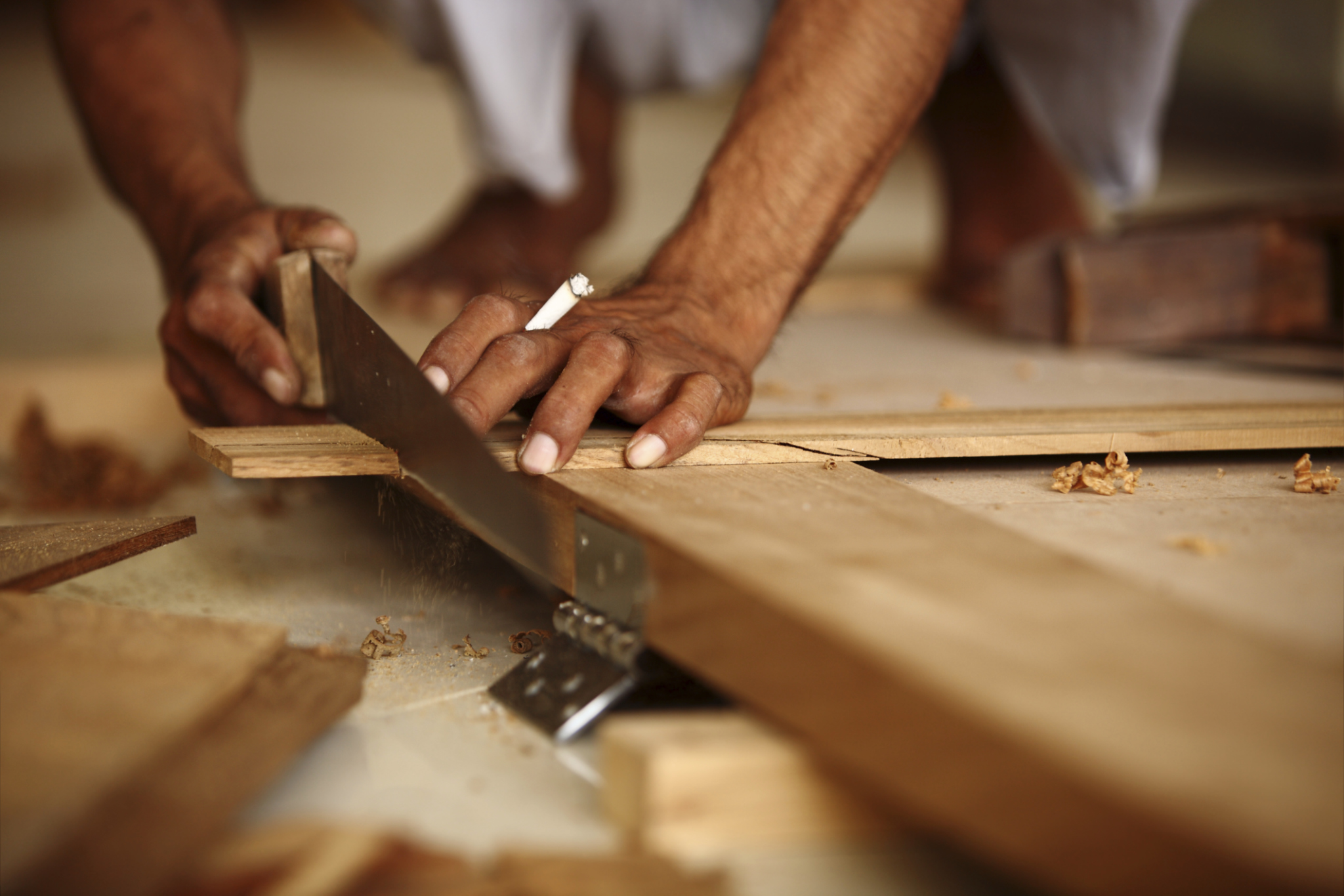 Carpenter making Modern Teak wood Pasted door Hand Saw Carpenter making Modern Teak wood Pasted door Hand Saw