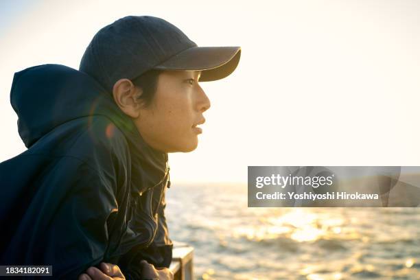 morning sun to the profile of young man - profile picture man stock pictures, royalty-free photos & images