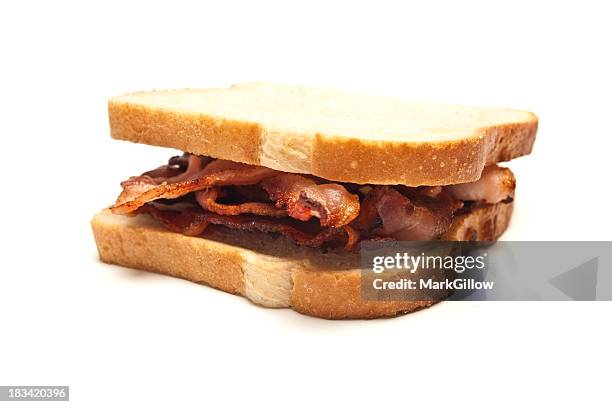 sandwich of bacon strips between two slices of white bread - bacon sandwich stock pictures, royalty-free photos & images