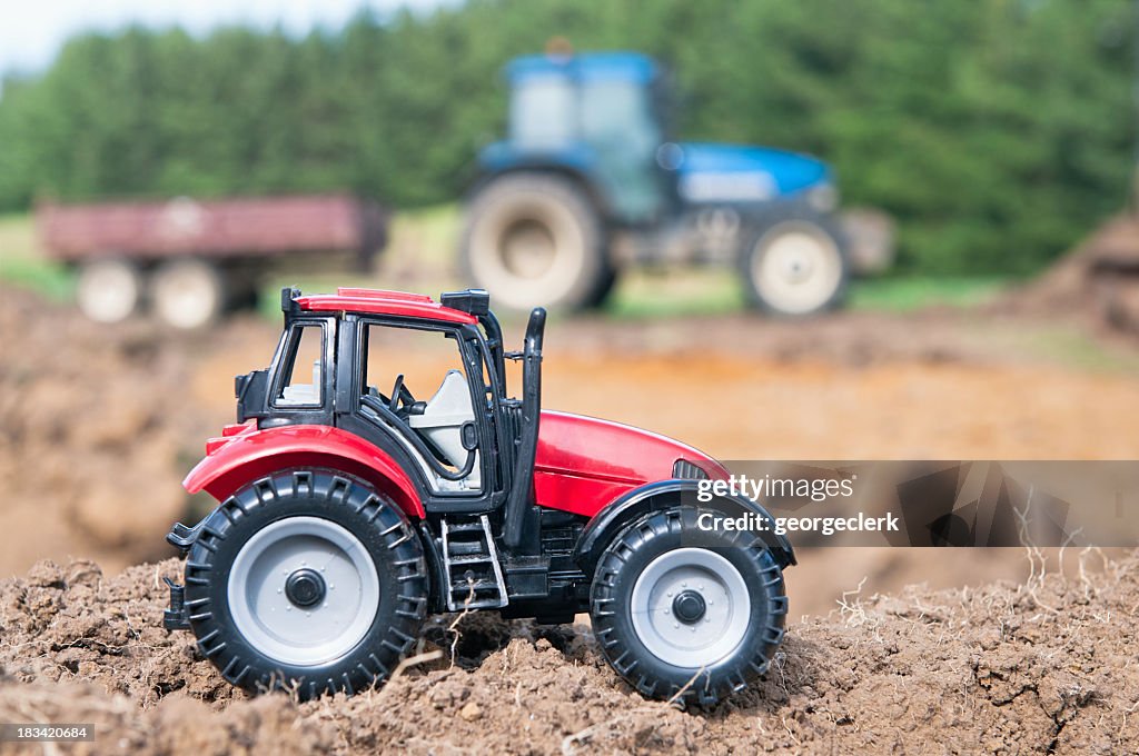 Toy tractor compared to the real thing