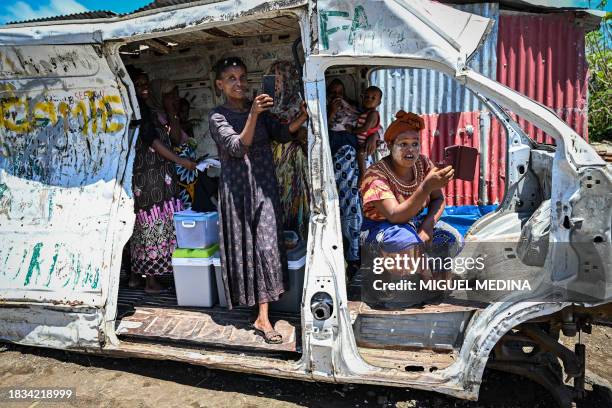 This photograph taken on December 8 shows residents in the Mavadzani shantytown, on the heights of Koungou, on the French Indian Ocean island of...