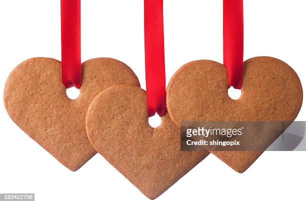 ginger cookie heart ornaments on white background - gingerbread men stockfoto's en -beelden