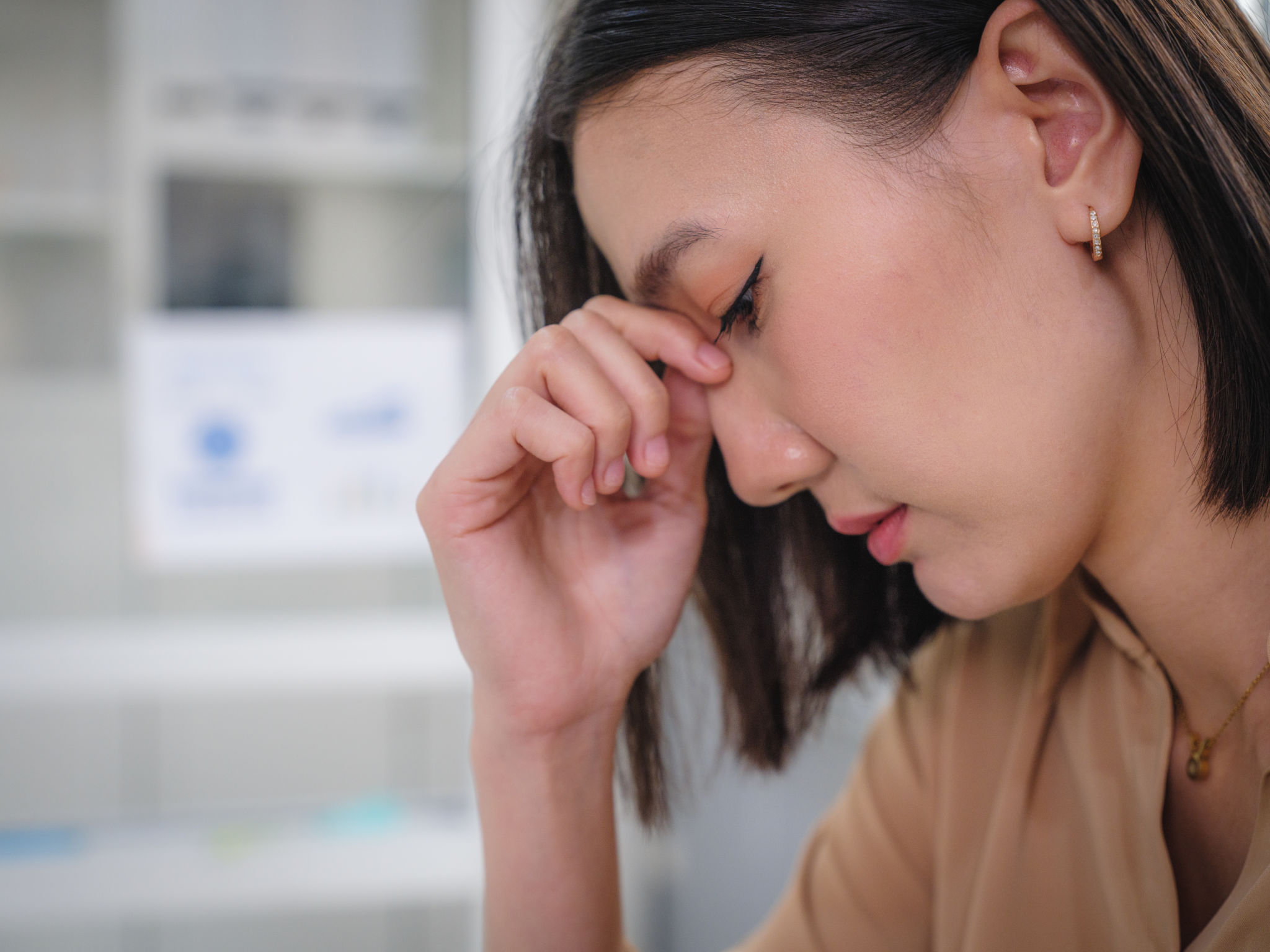 Portrait of upset Asian businesswomen feel strain or tired from her work Portrait of upset Asian businesswomen feel strain or tired from her work