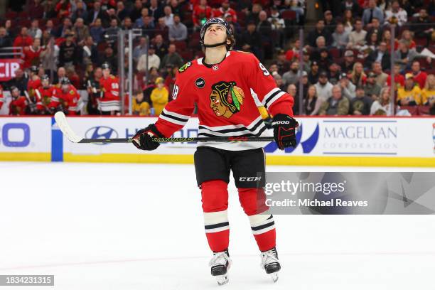 Connor Bedard of the Chicago Blackhawks reacts to a missed shot on goal against the Nashville Predators in overtime at the United Center on December...