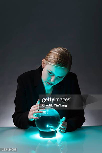 business woman with crystal ball predicting economic and market future - fortune teller table stock pictures, royalty-free photos & images