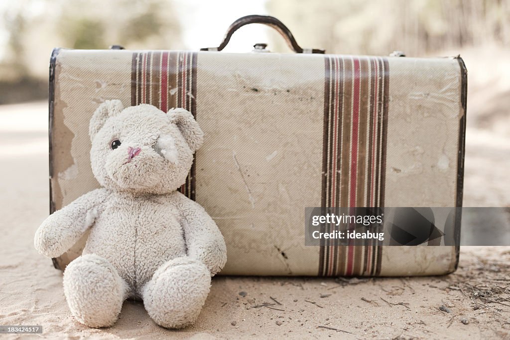 Abandoned Suitcase with Teddy Bear on Dirt Road