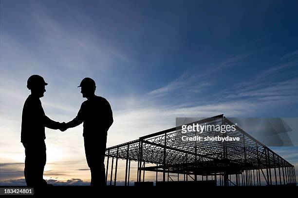 construction site handshake - construction site and silhouette stock pictures, royalty-free photos & images