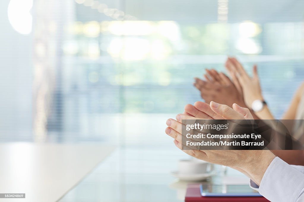 Clapping business people in office, hands only