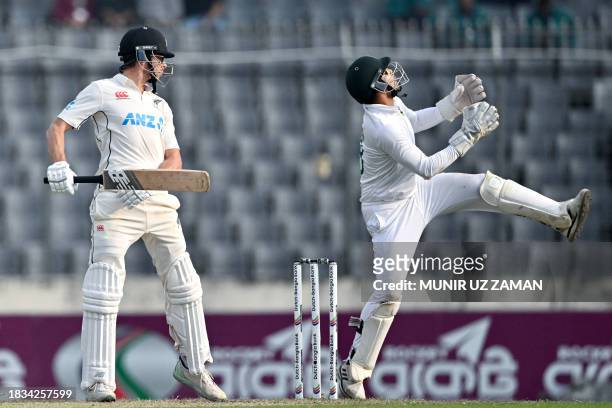 New Zealand's Mitchell Santner gestures after playing a shot as Bangladesh's Nurul Hasan looks on during the fourth day of second Test cricket match...