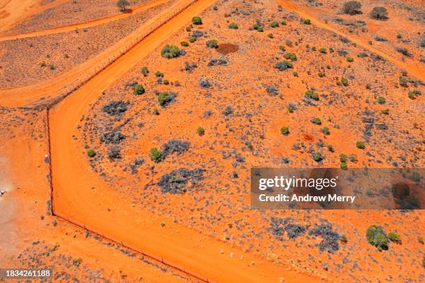 dingo fence, state boundaries outback australia - driving car australia road copy space sunlight travel destinations colour image day getting stock pictures, royalty-free photos & images