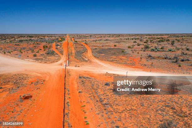 dingo or dog fence, state border outback australia - driving car australia road copy space sunlight travel destinations colour image day getting stock pictures, royalty-free photos & images