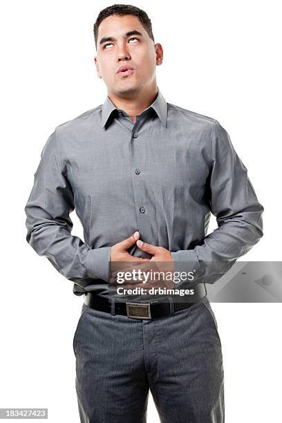 jeune homme avec les mains sur le ventre - rouler des yeux photos et images de collection