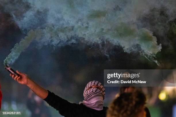 Protesters march in the street to denounce the Biden administration's support of Israel, which has killed thousands of Palestinian civilians so far...