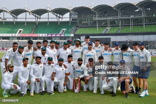 Bangladesh's and New Zealand's players pose with the trophy at the end of the second Test cricket match between Bangladesh and New Zealand at the...