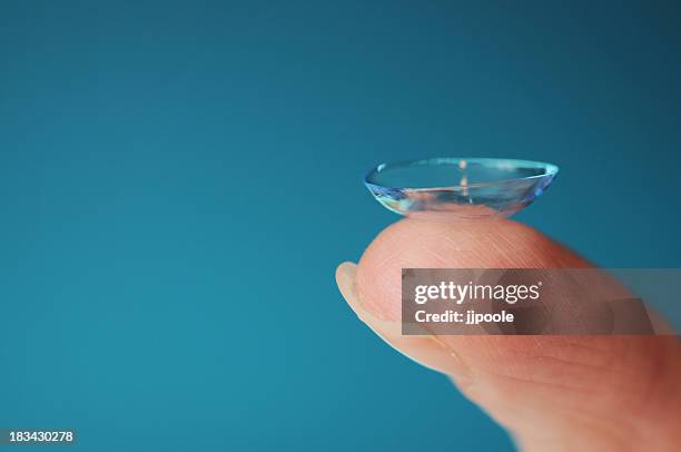 holding a contact lens on finger tip - lens eye stock pictures, royalty-free photos & images