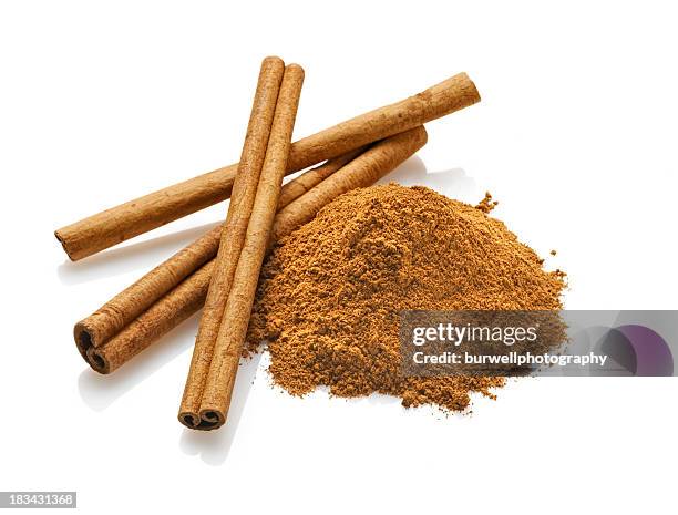 cinnamon sticks and powder, white background - cinnamon stock pictures, royalty-free photos & images