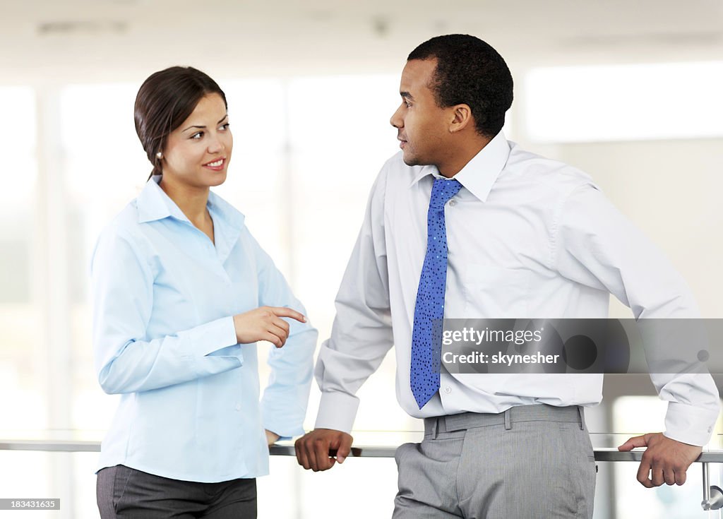 Two business colleagues are communicating at the workplace